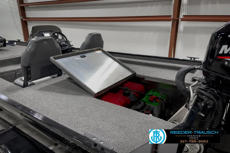 Slide: The Image of 2021 Lowe Skorpion 17 boat interior with open storage compartment and motor. - 21