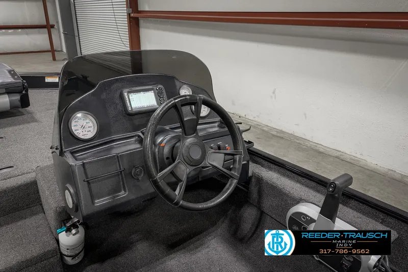 Slide: The Image of 2021 Lowe Skorpion 17 boat dashboard with steering wheel and gauges. - 24