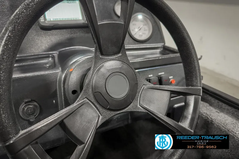 Slide: The Image of 2021 Lowe Skorpion 17 boat dashboard with steering wheel and gauges. - 25
