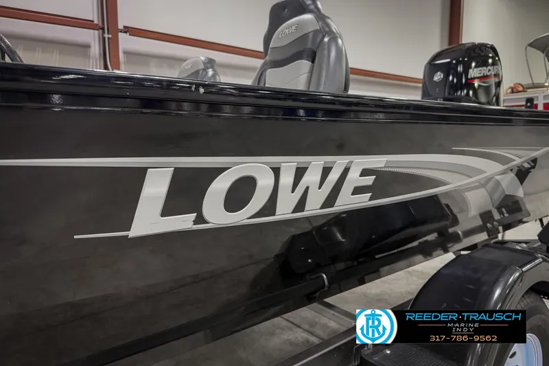 Slide: The Image of 2021 Lowe Skorpion 17 boat with sleek black design in showroom. - 39