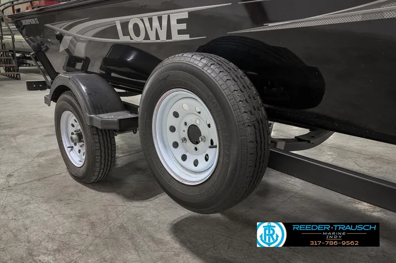 Slide: The Image of 2021 Lowe Skorpion 17 boat trailer with dual wheels in a showroom. - 42