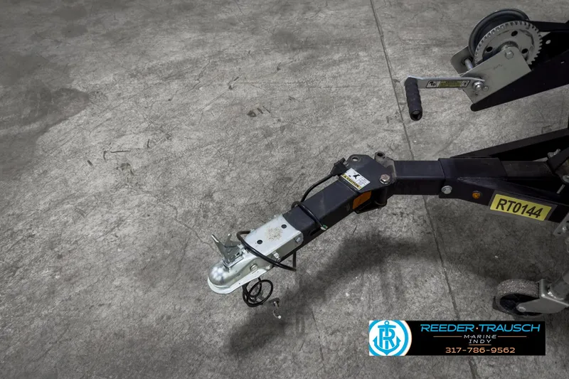 Slide: The Image of 2021 Lowe Skorpion 17 trailer hitch on concrete floor, Reeder-Trausch Marine logo visible. - 44