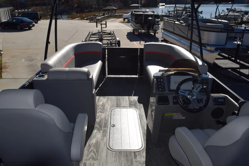 Slide: The Image of Interior of 2025 Qwest E-Class 824 RLS pontoon boat with modern seating and steering console. - 11