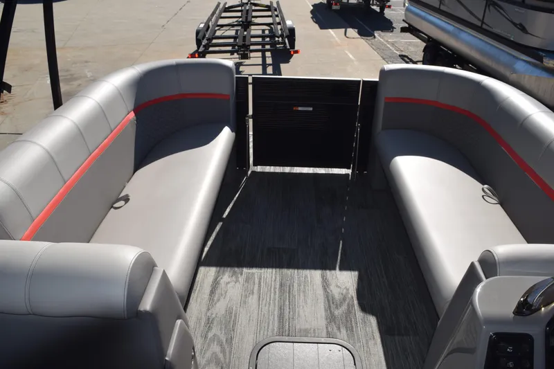 Slide: The Image of 2025 Qwest E-Class 824 RLS pontoon boat interior with gray seating and red accents. - 12