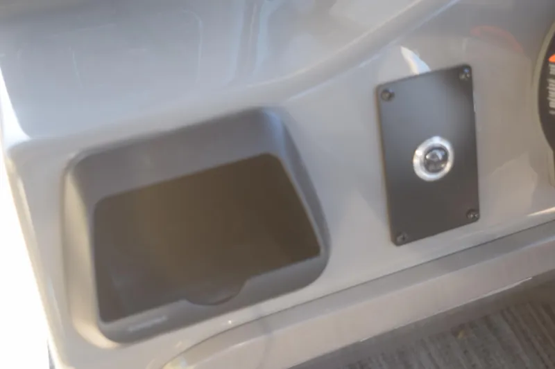 Slide: The Image of Control panel of 2025 Qwest E-Class 824 RLS boat, featuring a storage compartment. - 19