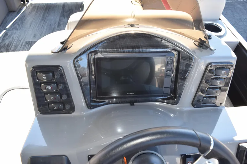 Slide: The Image of 2025 Qwest E-Class 824 RLS boat dashboard with control panel and display screen. - 21