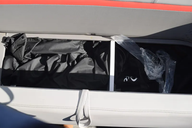 Slide: The Image of Storage compartment in 2025 Qwest E-Class 824 RLS boat, featuring organized interior space. - 24