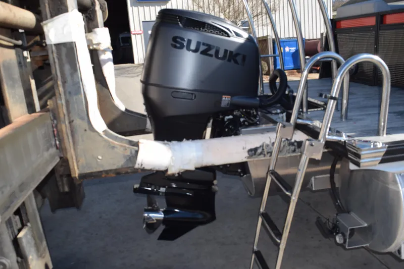 Slide: The Image of Suzuki outboard motor on 2025 Qwest E-Class 824 RLS boat, docked with ladder. - 3