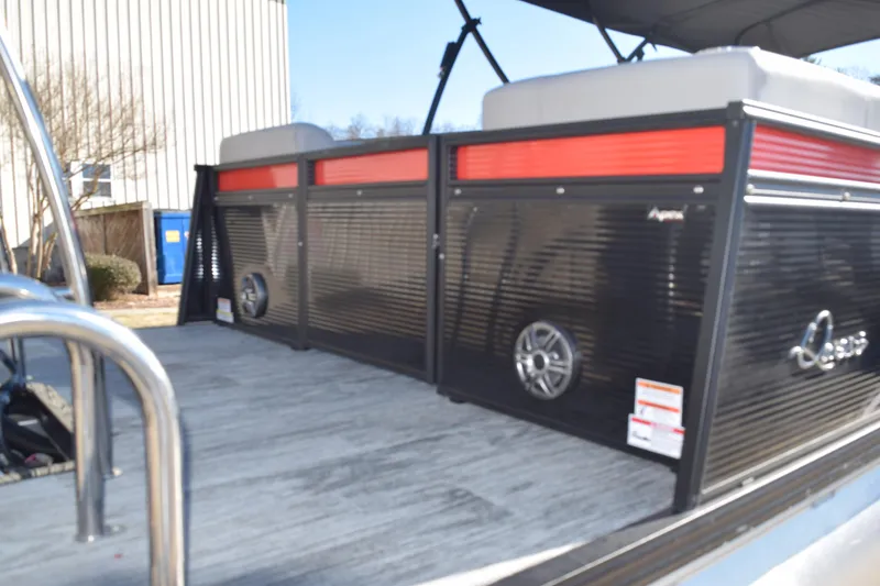 Slide: The Image of 2025 Qwest E-Class 824 RLS pontoon boat with sleek black and red design. - 6