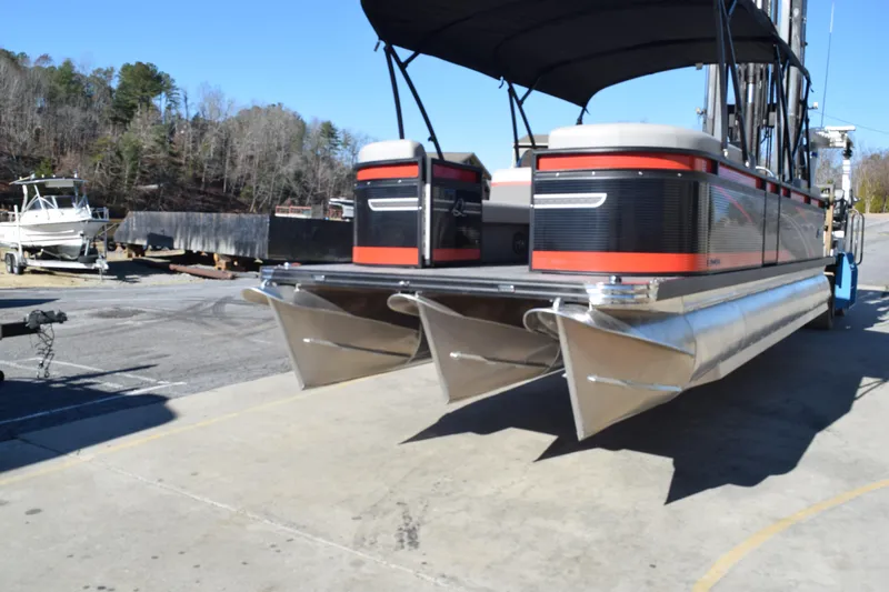 Slide: The Image of 2025 Qwest E-Class 824 RLS pontoon boat at a marina dock. - 7