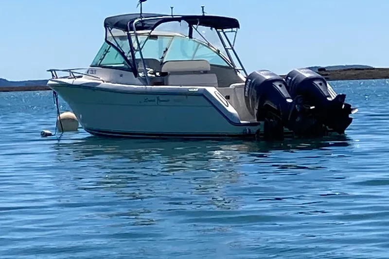 Slide: The Image of 2003 Pursuit 2670 Denali LS boat with twin engines on calm water. - 1