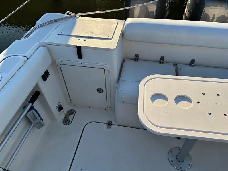 Slide: The Image of 2003 Pursuit 2670 Denali LS boat interior with seating and table. - 11