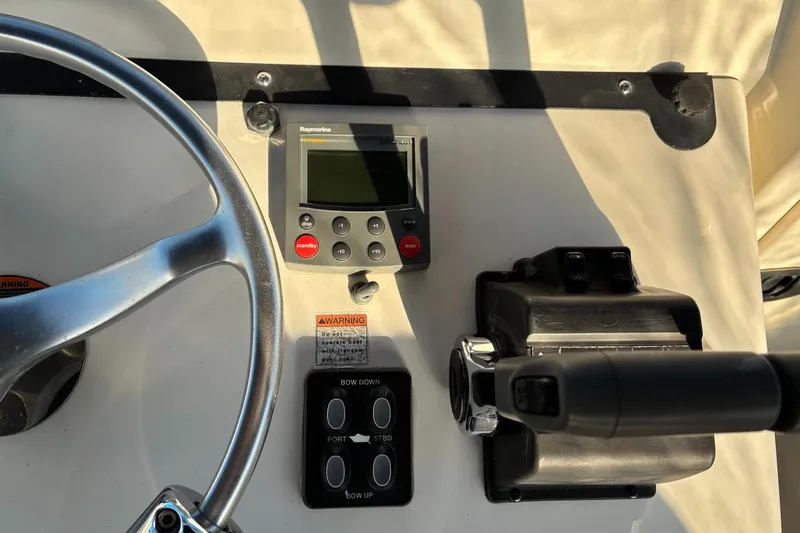 Slide: The Image of 2003 Pursuit 2670 Denali LS boat dashboard with steering wheel and control panel. - 15