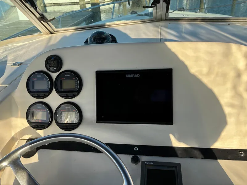 Slide: The Image of Dashboard of 2003 Pursuit 2670 Denali LS boat with gauges and Simrad display. - 16