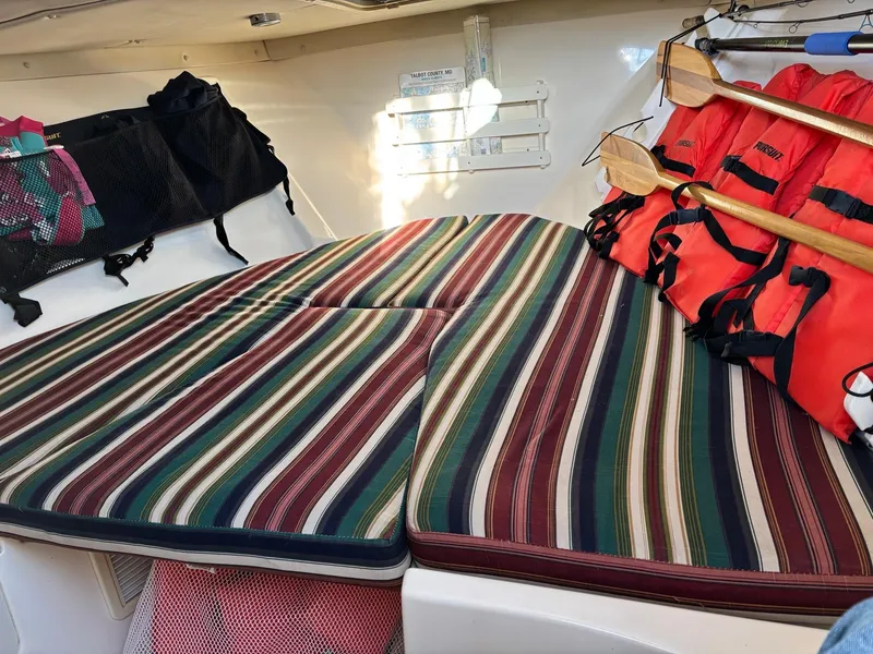 Slide: The Image of Interior of 2003 Pursuit 2670 Denali LS boat with striped cushions and safety gear. - 21