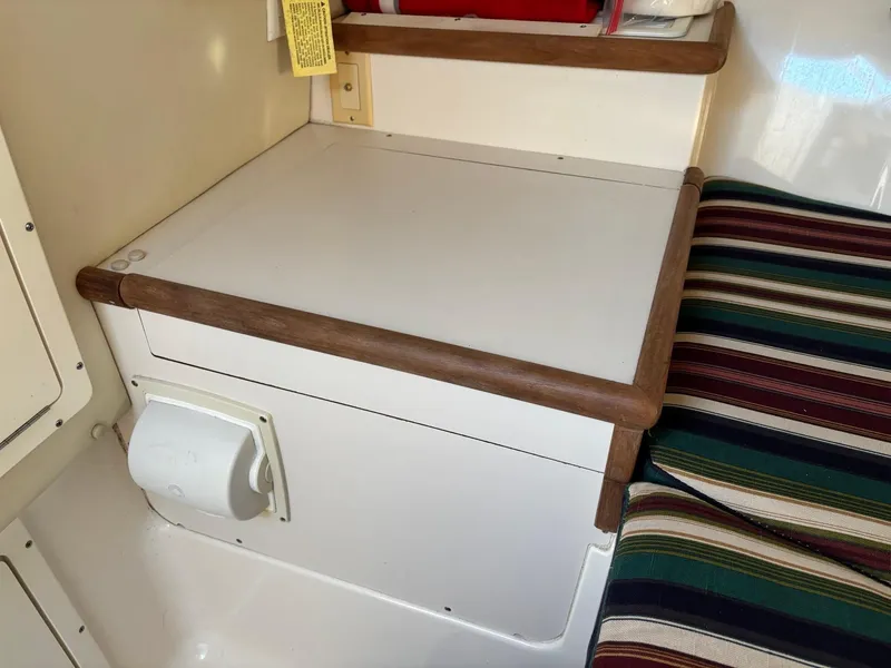 Slide: The Image of 2003 Pursuit 2670 Denali LS cabin interior with seating and storage area. - 23