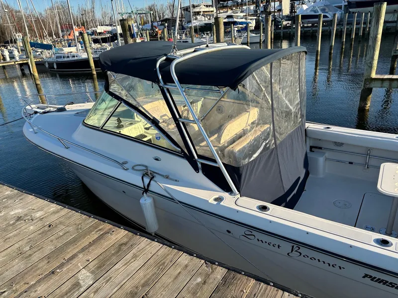 Slide: The Image of 2003 Pursuit 2670 Denali LS boat docked at marina with canopy and clear enclosure. - 3