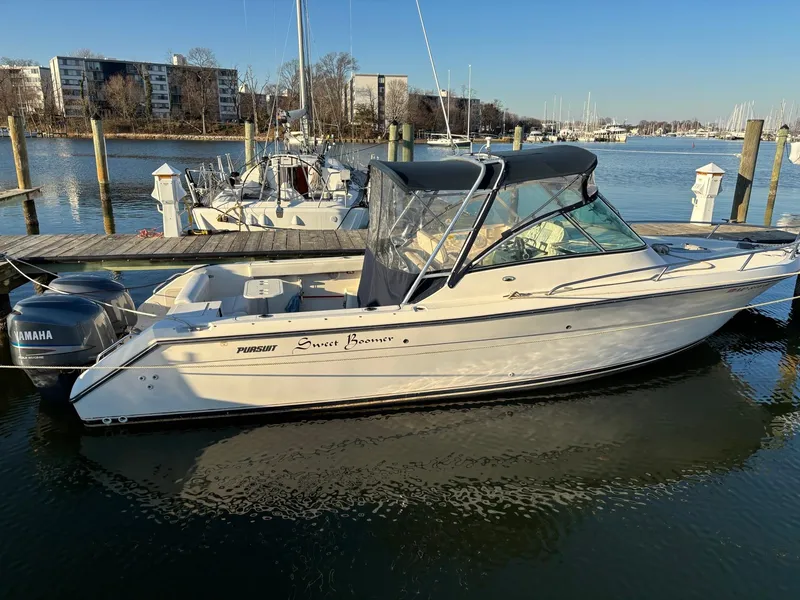 Slide: The Image of 2003 Pursuit 2670 Denali LS boat docked in a marina with Yamaha outboard motor. - 4