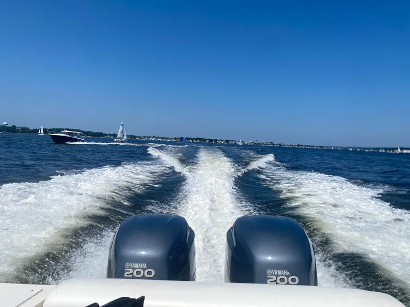 Slide: The Image of 2003 Pursuit 2670 Denali LS boat with twin Yamaha 200 engines cruising on open water. - 8