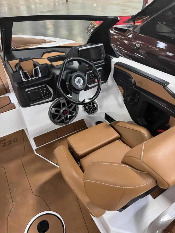 Slide: The Image of 2023 Axis T220 boat interior with tan leather seats and modern dashboard. - 4