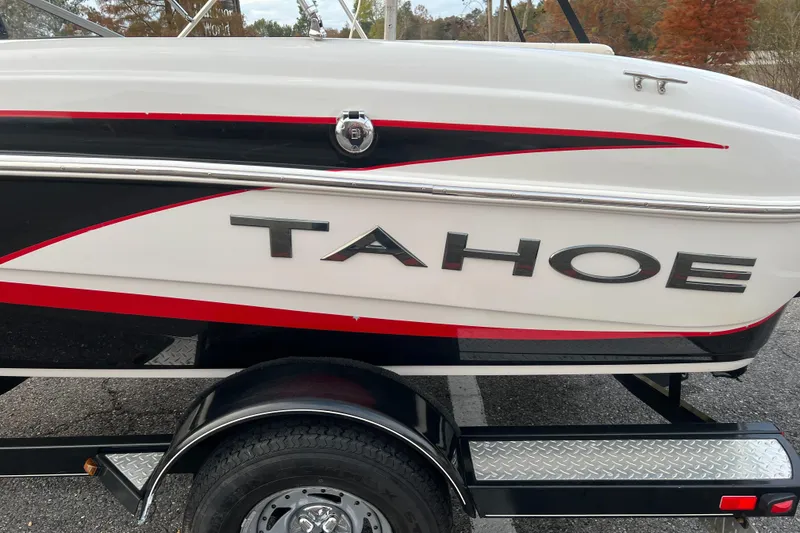 Slide: The Image of 2013 Tahoe Q5i boat on trailer, featuring sleek design and bold graphics. - 12