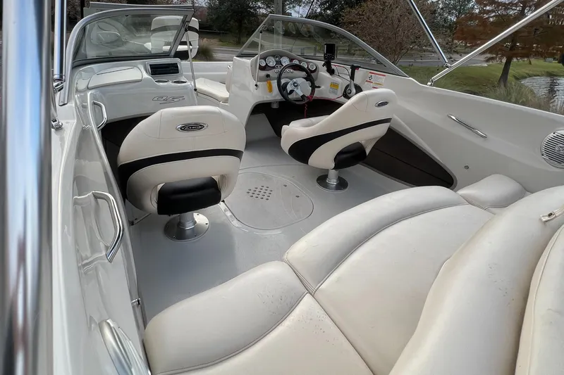 Slide: The Image of Interior of a 2013 Tahoe Q5i boat with white seating and dashboard. - 6