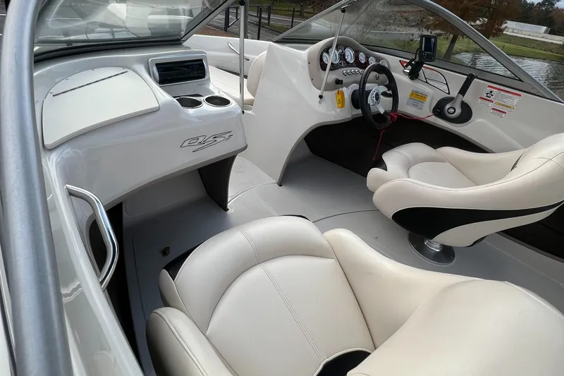 Slide: The Image of 2013 Tahoe Q5i boat interior with white leather seats and modern dashboard. - 7