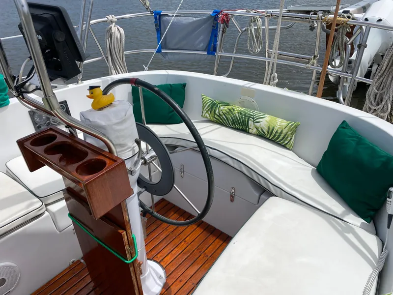 Slide: The Image of 1986 Nonsuch 30 Ultra sailboat cockpit with cushions and wooden flooring. - 13