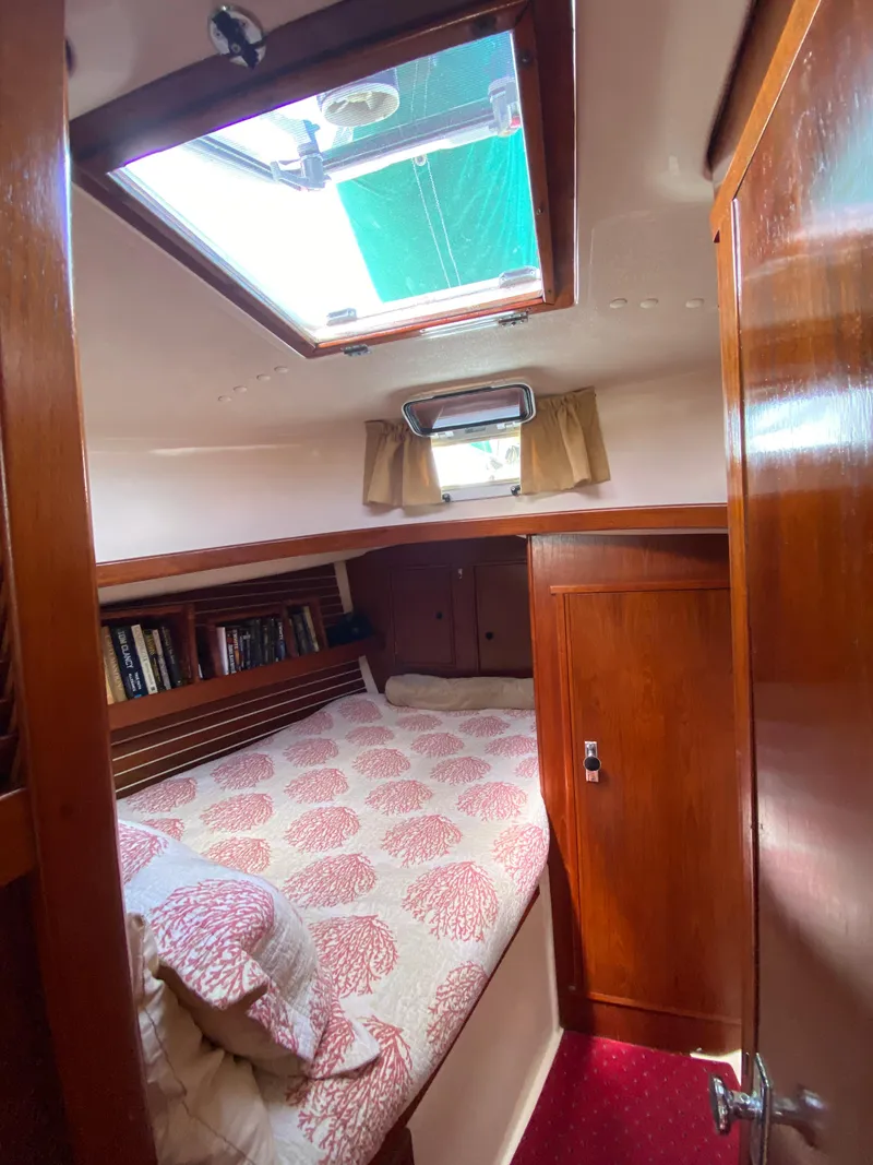 Slide: The Image of Cozy cabin interior of 1986 Nonsuch 30 Ultra sailboat with skylight and wooden furnishings. - 22