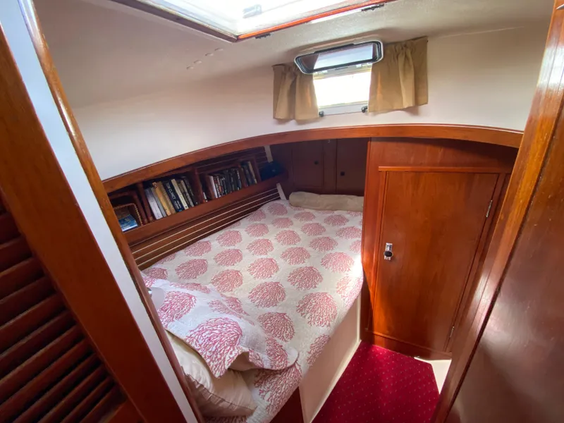 Slide: The Image of Cozy cabin interior of 1986 Nonsuch 30 Ultra sailboat with bed and bookshelf. - 25