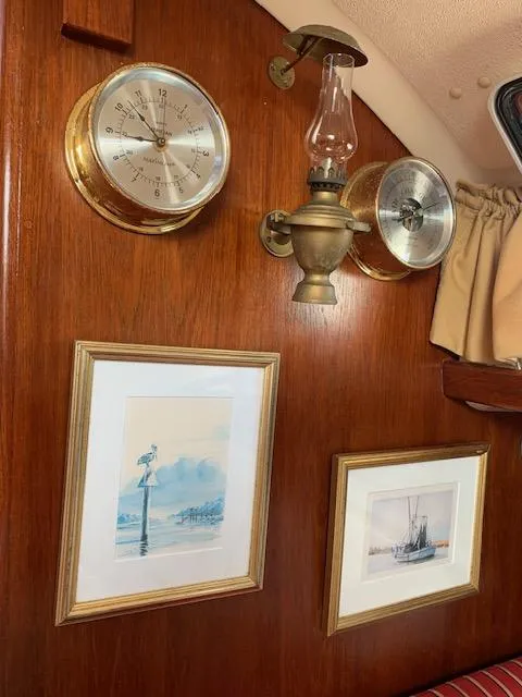 Slide: The Image of Nautical-themed cabin interior with barometer, clock, and framed art on a Nonsuch 30 Ultra, 1986. - 26
