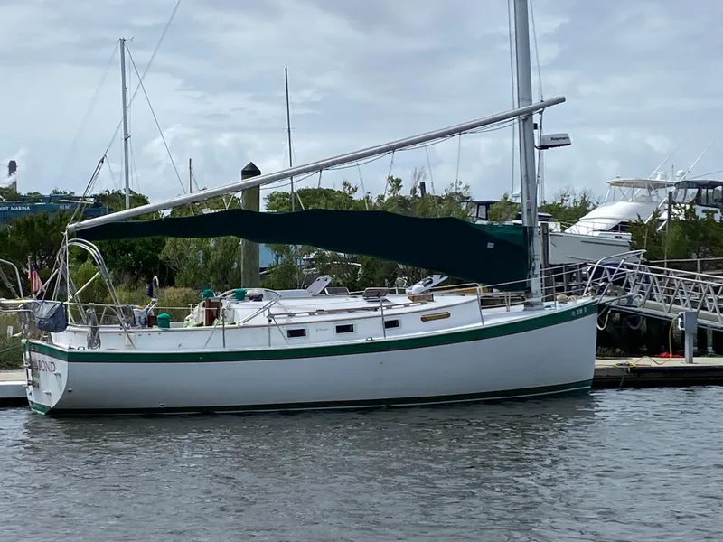 Slide: The Image of 1986 Nonsuch 30 Ultra sailboat docked in a marina. - 3