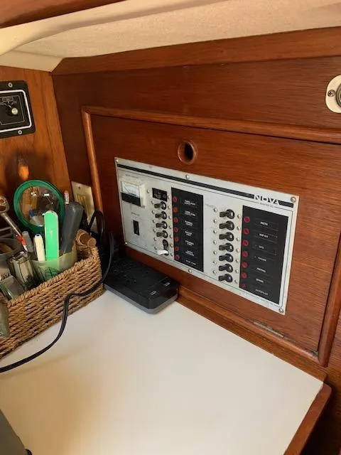 Slide: The Image of Electrical panel inside 1986 Nonsuch 30 Ultra sailboat with wooden interior. - 31