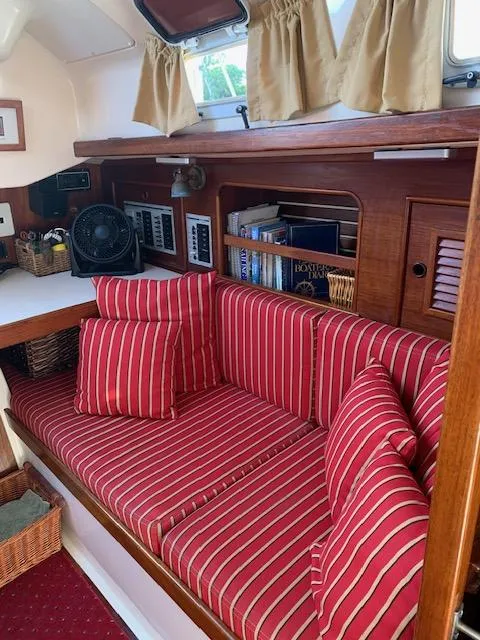 Slide: The Image of 1986 Nonsuch 30 Ultra interior with red striped cushions and wooden accents. - 33