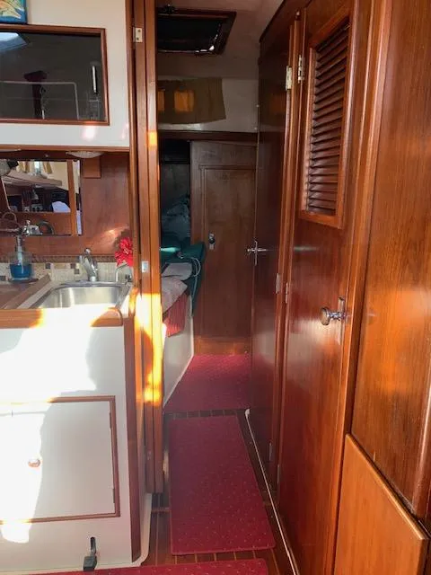 Slide: The Image of Interior of 1986 Nonsuch 30 Ultra sailboat with wood cabinetry and compact kitchen. - 39