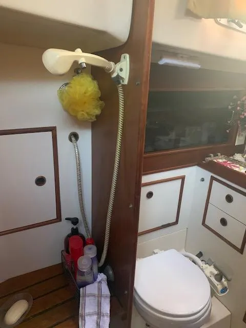 Slide: The Image of 1986 Nonsuch 30 Ultra yacht bathroom with shower, toilet, and storage cabinets. - 40