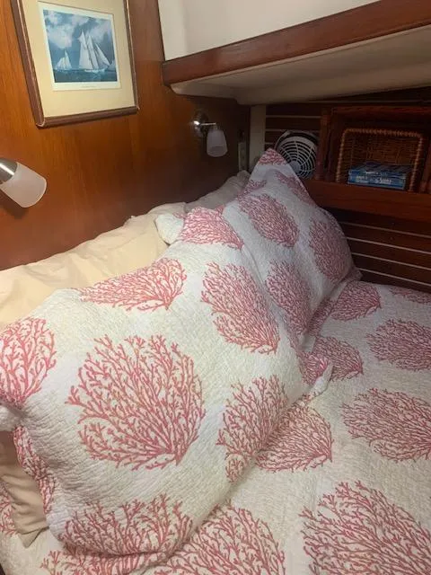 Slide: The Image of Cozy cabin bed in 1986 Nonsuch 30 Ultra sailboat with coral-patterned bedding. - 46