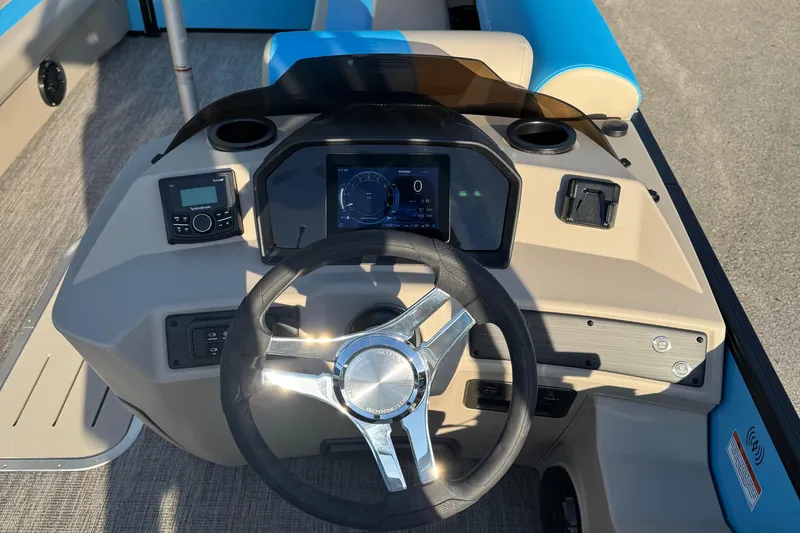 Slide: The Image of 2025 Bennington 23 SSB boat dashboard with steering wheel and digital display. - 10