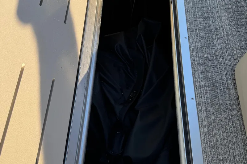 Slide: The Image of Storage compartment of 2025 Bennington 23 SSB boat with shadow and textured flooring. - 17
