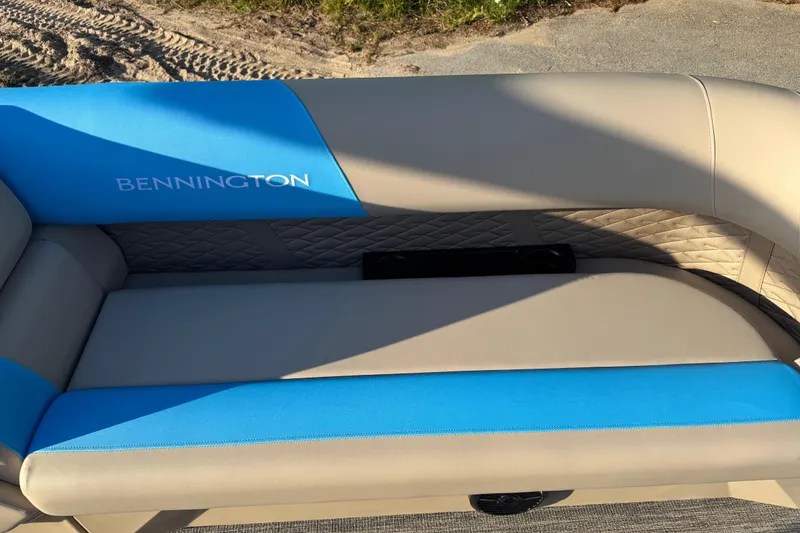 Slide: The Image of 2025 Bennington 23 SSB boat seat with blue and beige upholstery, outdoor setting. - 18