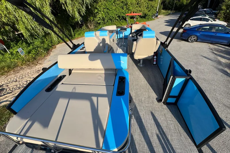 Slide: The Image of 2025 Bennington 23 SSB pontoon boat with blue accents and spacious seating. - 23