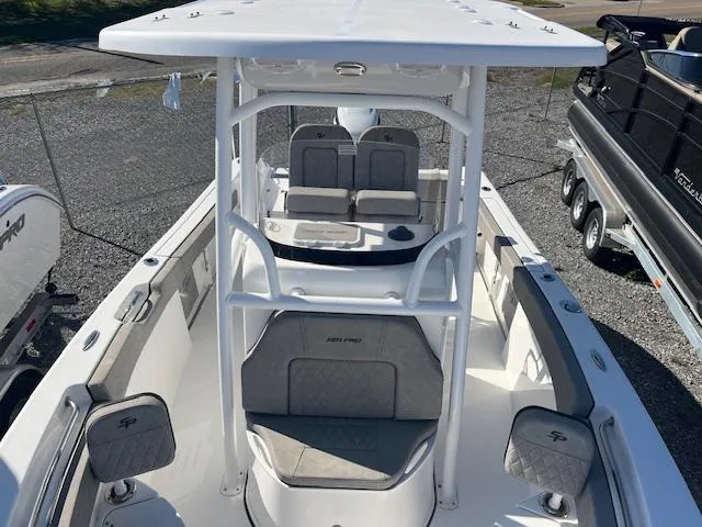 Slide: The Image of 2023 Sea Pro 219CC boat with T-top and seating, docked on a trailer. - 10