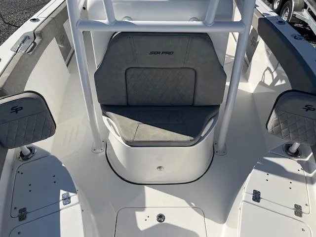 Slide: The Image of 2023 Sea Pro 219CC boat interior with cushioned seating and storage compartments. - 12