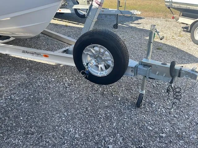 Slide: The Image of 2023 Sea Pro 219CC boat trailer with spare tire on gravel surface. - 4