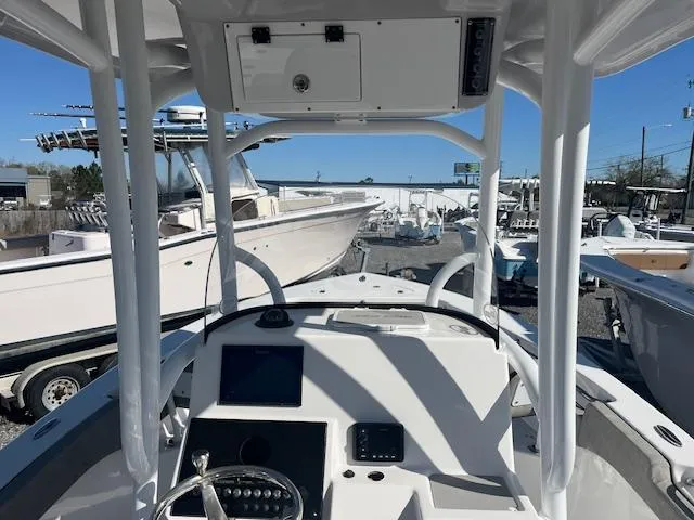 Slide: The Image of 2023 Sea Pro 219CC boat dashboard with steering wheel and navigation equipment. - 7