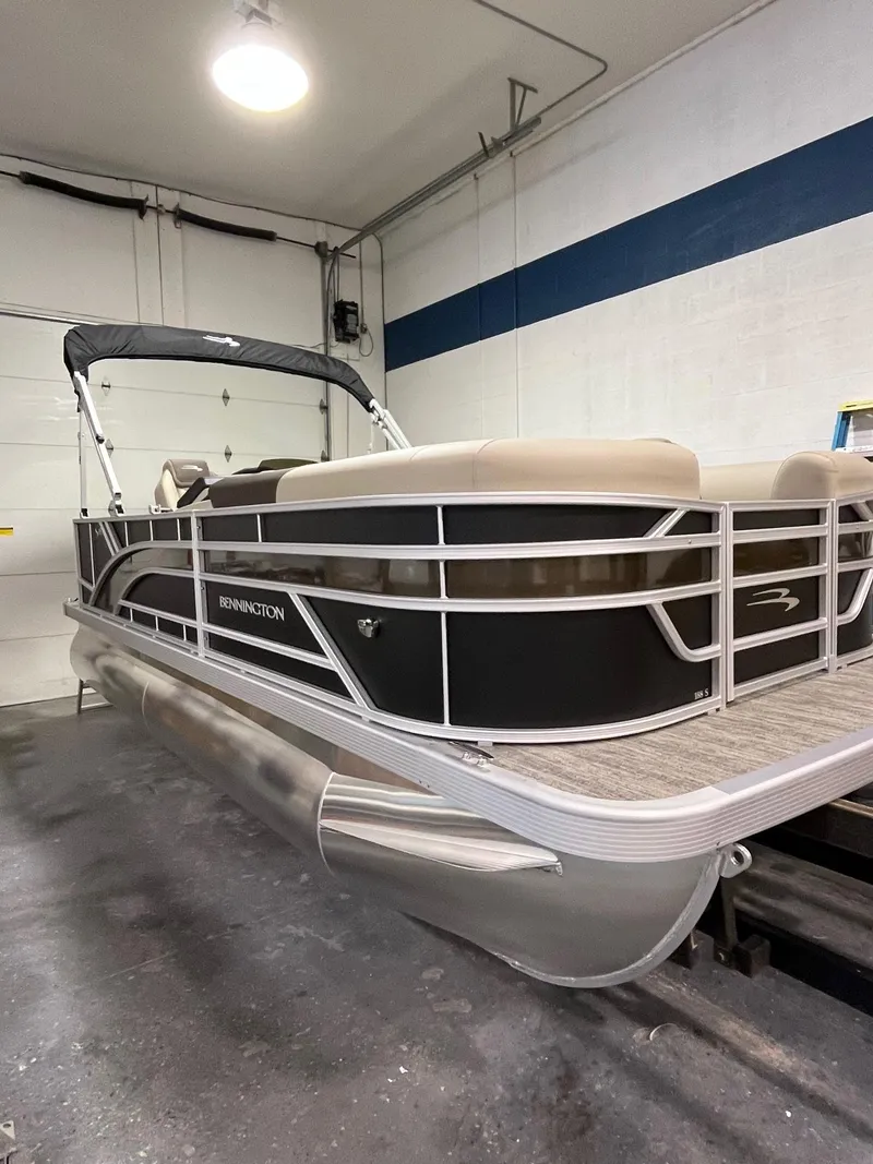 Slide: The Image of 2025 Bennington 188 SL pontoon boat in a garage setting. - 1
