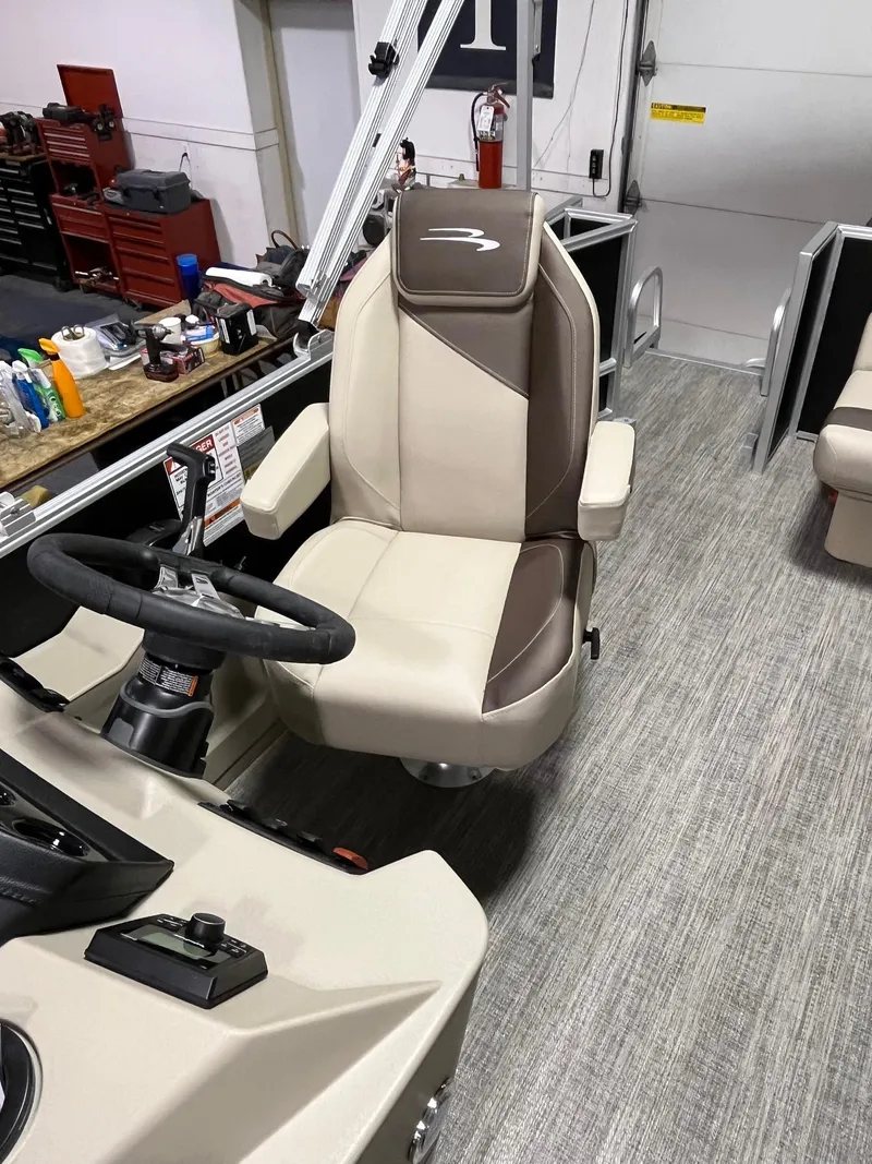 Slide: The Image of 2025 Bennington 188 SL boat interior with captain's chair and steering wheel. - 4