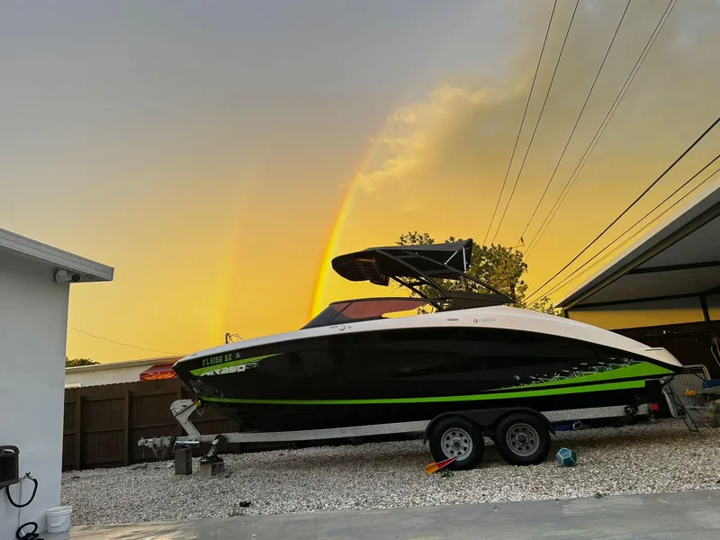 Slide: The Image of 2021 Yamaha AR250 boat on trailer at sunset with double rainbow. - 1