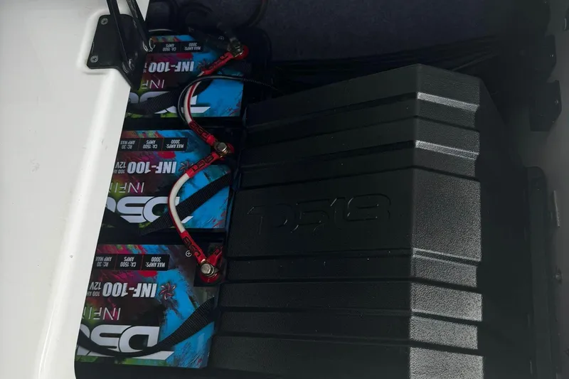 Slide: The Image of Battery compartment of 2021 Yamaha AR250 boat with connected cables. - 10