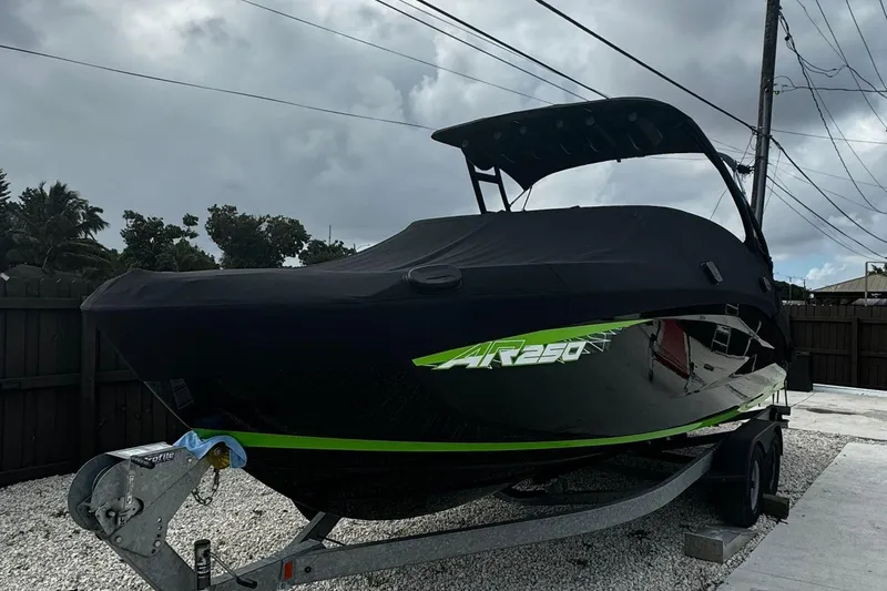 Slide: The Image of 2021 Yamaha AR250 boat on trailer, covered, with overcast sky. - 12
